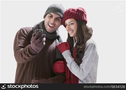 Young couple looking at their photos in mobile phone
