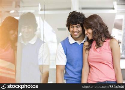 Young couple looking at window display together