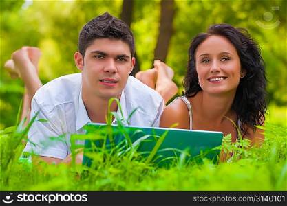 Young couple lying and enjoying at park