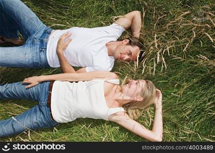 Young couple lying in a field