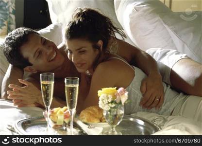 Young couple lying on a bed together