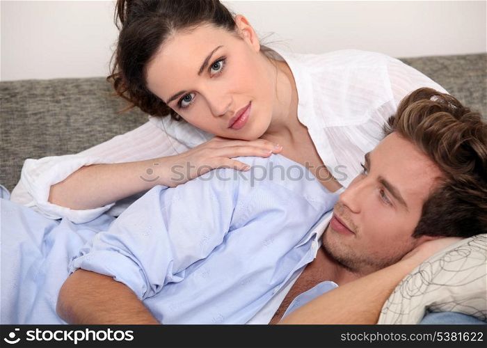 Young couple lying on a couch
