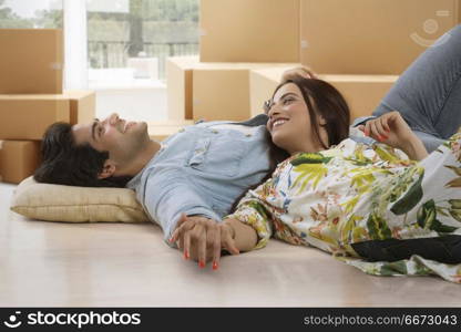 Young couple lying on floor in living room