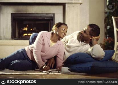 Young couple lying on the floor together
