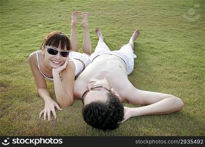 Young couple lying on the grass