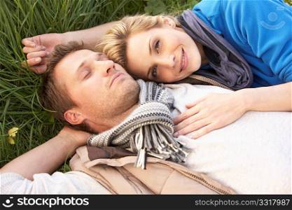 Young couple lying together on grass