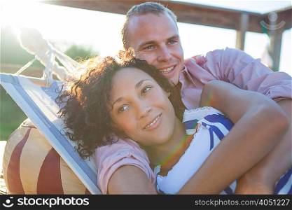 Young couple lying together on hammock, close up