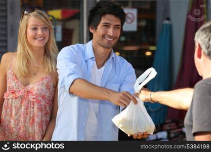 Young couple making purchases