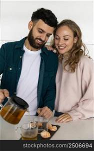 young couple making tea home together
