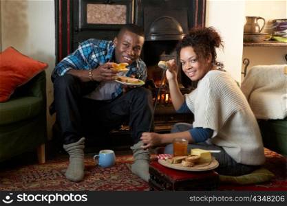 Young couple making toast on open fire