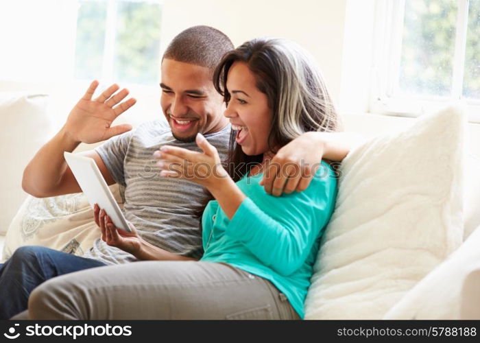 Young Couple Making Video Call Using Digital Tablet