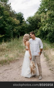 young couple of newlyweds on a walk in a pine forest