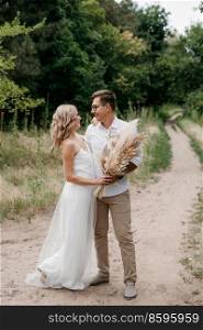 young couple of newlyweds on a walk in a pine forest