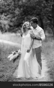 young couple of newlyweds on a walk in a pine forest