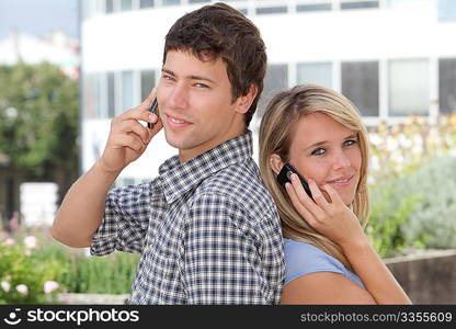 Young couple of students with mobile phone