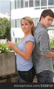 Young couple of students with mobile phone