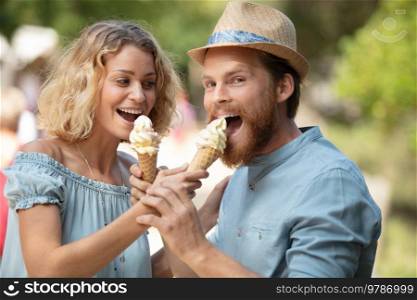 young couple offer ice cream outdoors sunny day