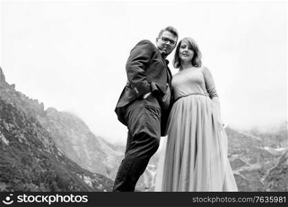 young couple on a walk near the lake surrounded by the Carpathian mountains