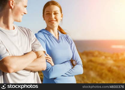 Young couple on beach in sportwear. Young couple on beach wearing sportwear