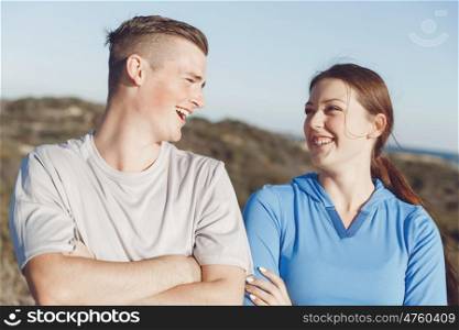 Young couple on beach in sportwear. Young couple on beach wearing sportwear