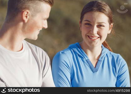 Young couple on beach in sportwear. Young couple on beach wearing sportwear