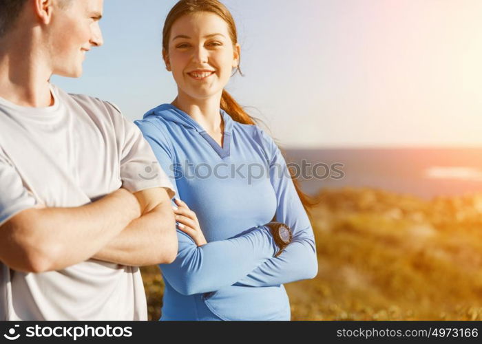 Young couple on beach in sportwear. Young couple on beach wearing sportwear