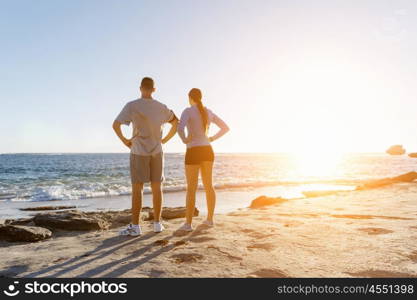 Young couple on beach training together. Young couple on beach training and exercising together