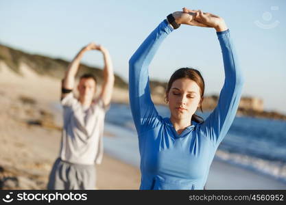 Young couple on beach training together. Young couple on beach training and exercising together