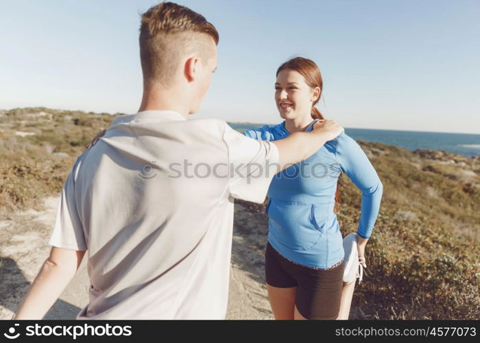 Young couple on beach training together. Young couple on beach training and exercising together