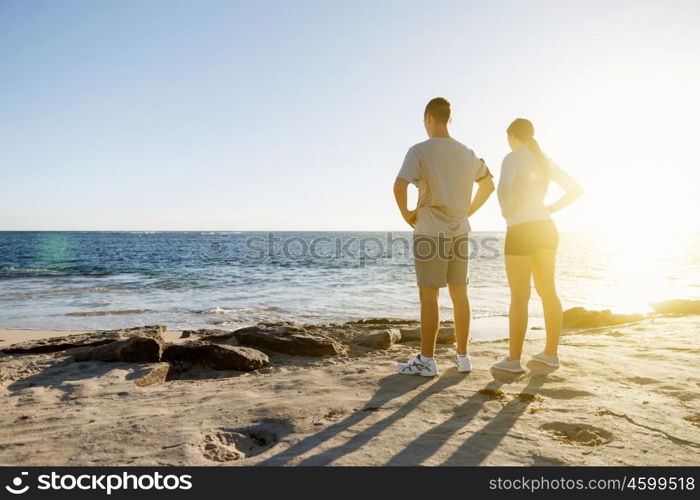 Young couple on beach training together. Young couple on beach training and exercising together