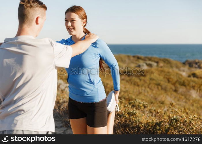 Young couple on beach training together. Young couple on beach training and exercising together