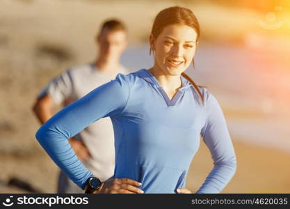 Young couple on beach training together. Young couple on beach training and exercising together