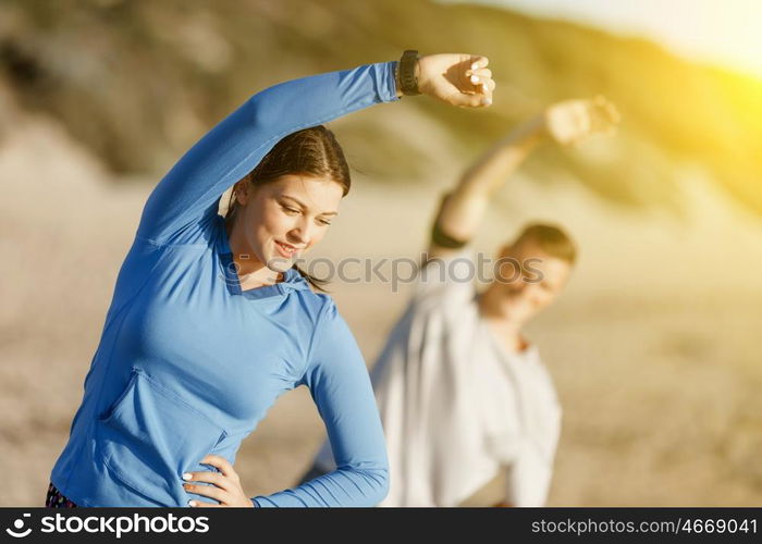 Young couple on beach training together. Young couple on beach training and exercising together