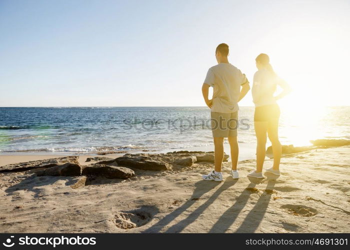 Young couple on beach training together. Young couple on beach training and exercising together