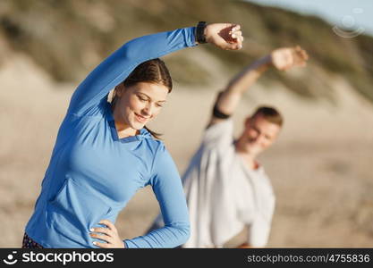 Young couple on beach training together. Young couple on beach training and exercising together