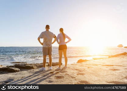 Young couple on beach training together. Young couple on beach training and exercising together