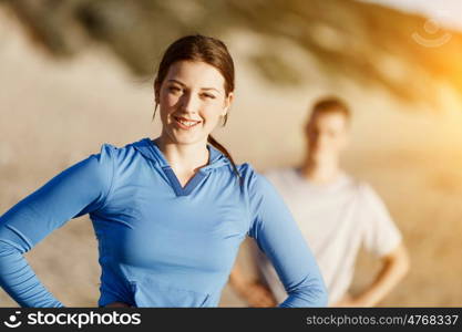 Young couple on beach training together. Young couple on beach training and exercising together