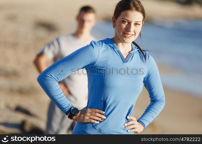 Young couple on beach training together. Young couple on beach training and exercising together