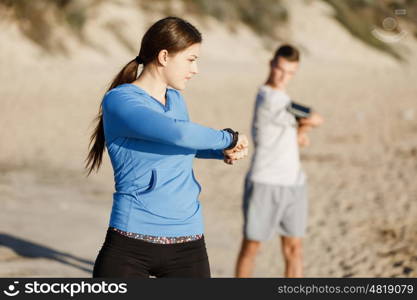 Young couple on beach training together. Young couple on beach training and exercising together