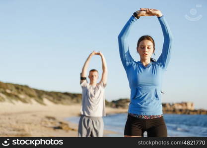 Young couple on beach training together. Young couple on beach training and exercising together