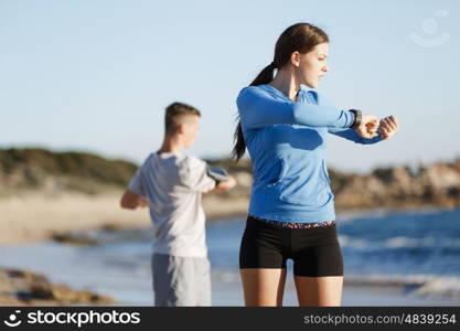 Young couple on beach training together. Young couple on beach training and exercising together