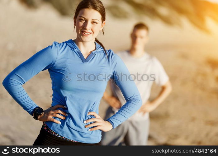 Young couple on beach training together. Young couple on beach training and exercising together