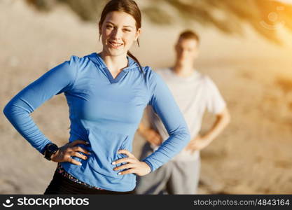 Young couple on beach training together. Young couple on beach training and exercising together