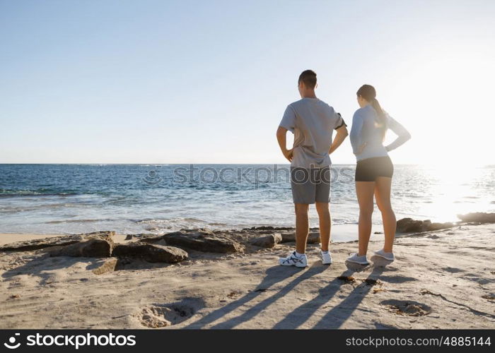 Young couple on beach training together. Young couple on beach training and exercising together