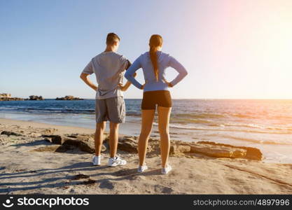 Young couple on beach training together. Young couple on beach training and exercising together