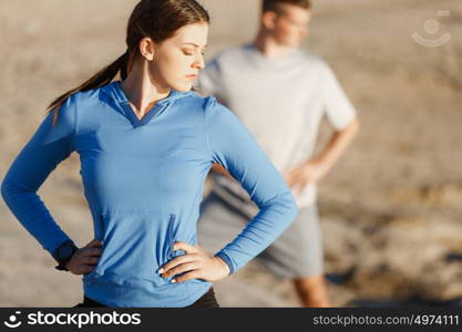 Young couple on beach training together. Young couple on beach training and exercising together