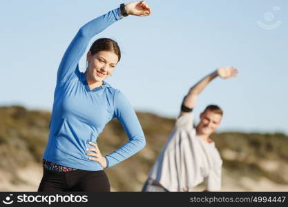 Young couple on beach training together. Young couple on beach training and exercising together