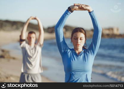 Young couple on beach training together. Young couple on beach training and exercising together