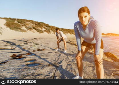 Young couple on beach training together. Young couple on beach training and exercising together