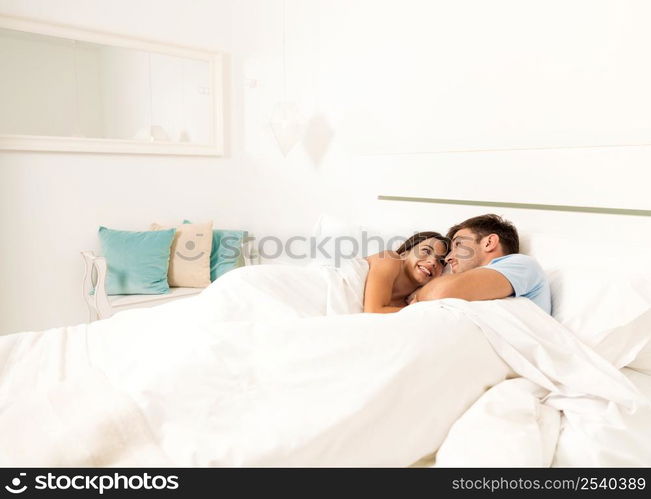 Young couple on bed and having a good time